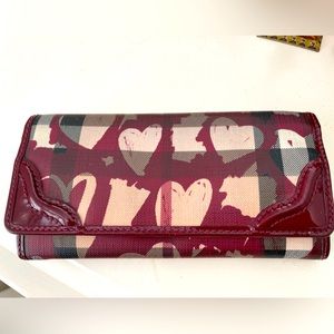 Burberry wallet burgundy and tan with heart design. Very good condition.